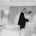 A quiet moment sees bride and groom romantically kissing in the reception room of Dunmore House Hotel West Cork