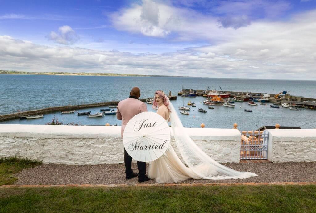 Amanda & Andrew exchanging vows in a breathtaking ceremony at Garryvoe Hotel, Cork – JOD Photography