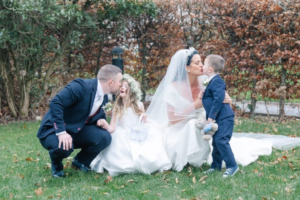 Bride and groom kiss their children on their wedding day in Cork Hotel venue