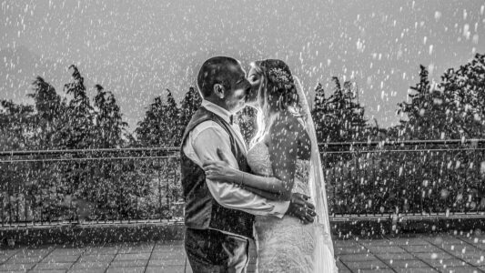 Bride and groom kissing in the rain at Blair Cove, Cork, JOD'Photography