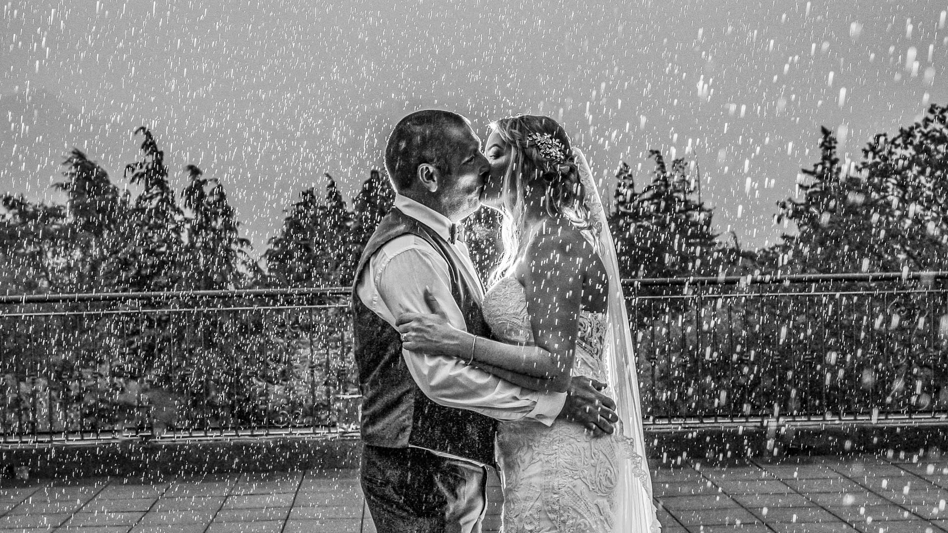 Bride and groom kissing in the rain at Blair Cove, Cork, JOD'Photography