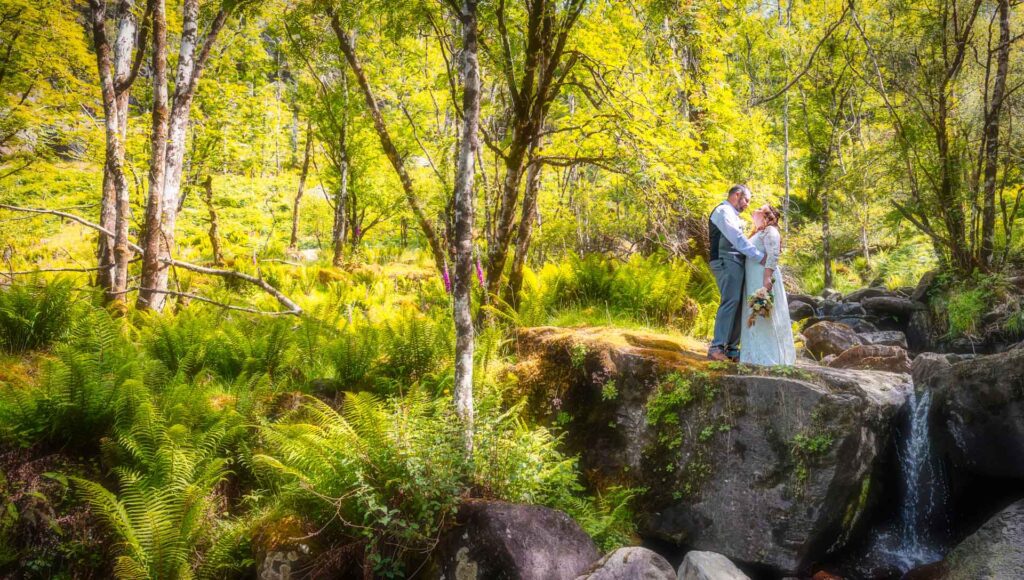 Bride and groom lost in the enchanting woods of Gougane barra Cork Ireland