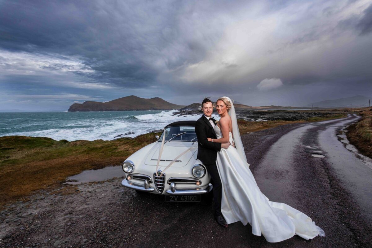 Bride and groom posing in front of the wild Atlantic way in valentia island Co Kerry