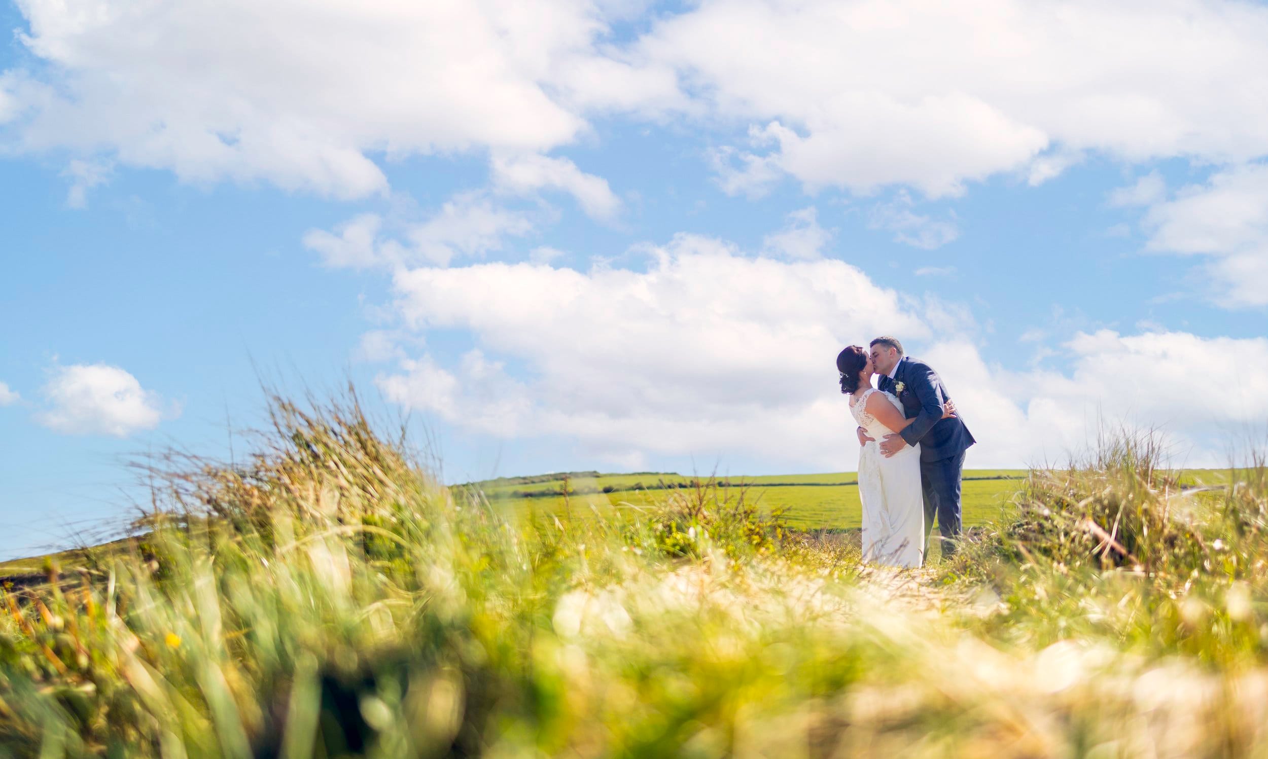 Bride and groom romantically kissing on the mountains in West Cork