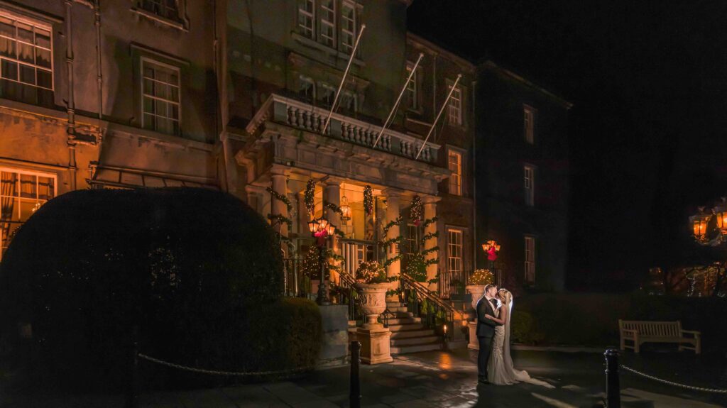 Bride and groom sharing a kiss at Christmas Outside the Great Southern Hotel in Killarney