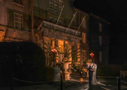 Bride and groom sharing a kiss at Christmas Outside the Great Southern Hotel in Killarney