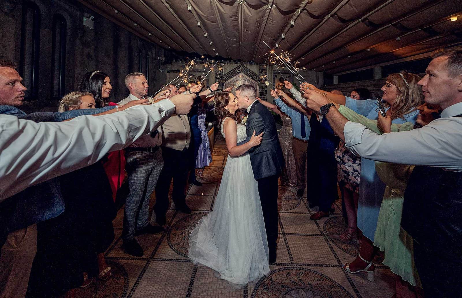Bride and groom sharing a kiss by the beautiful mountain backdrop in Cork, JOD'Photography