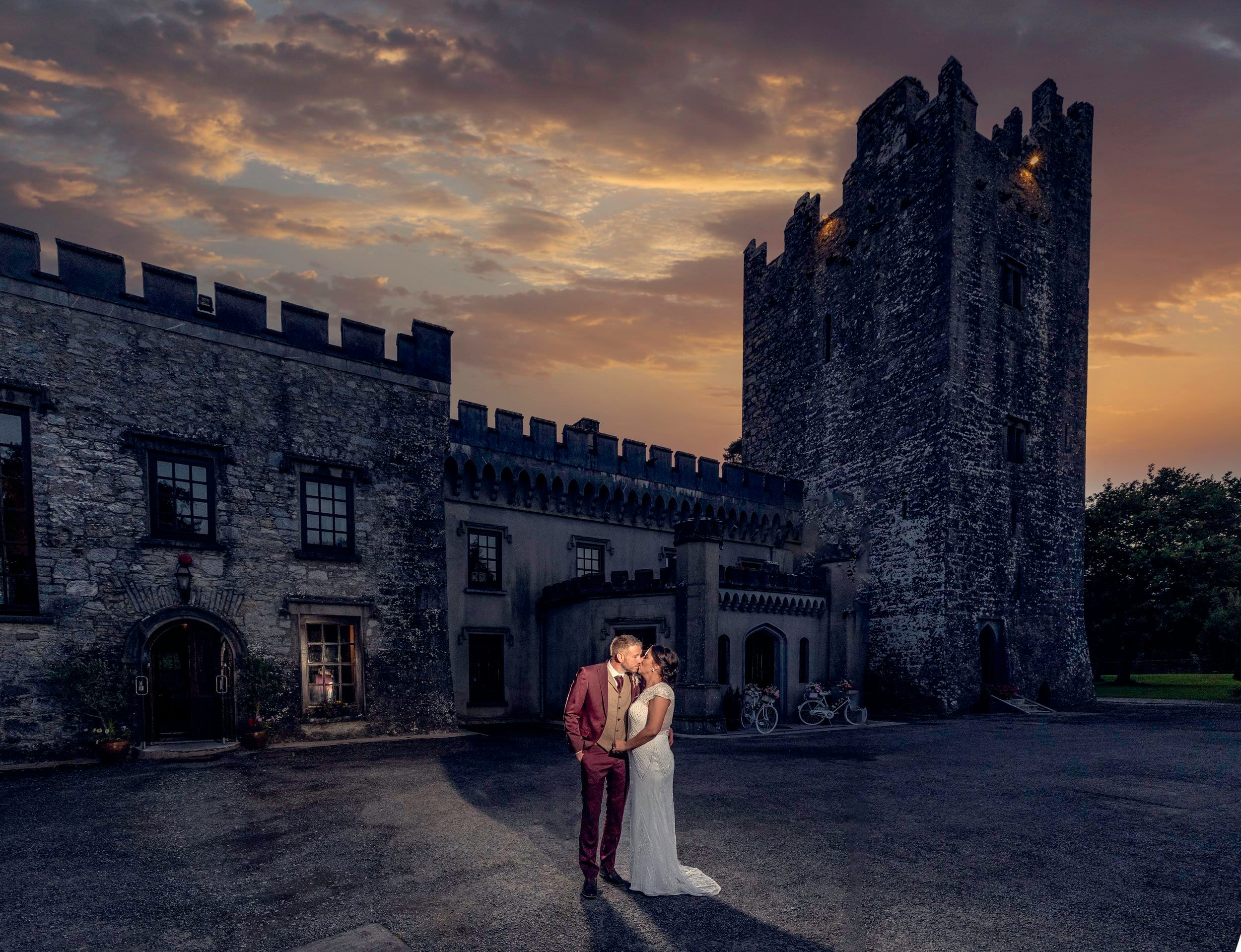 Bride and groom sharing a kiss in front of Blackwater castle Co Cork