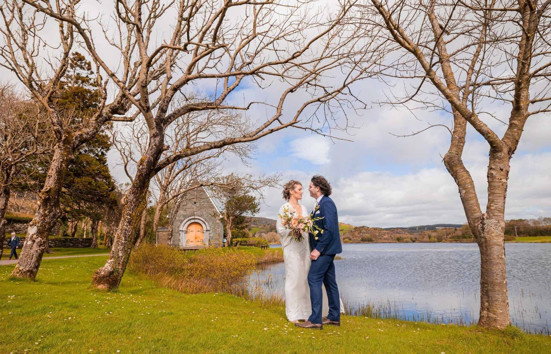 Bride and groom sharing a moment outside Gougane barra church Co Cork