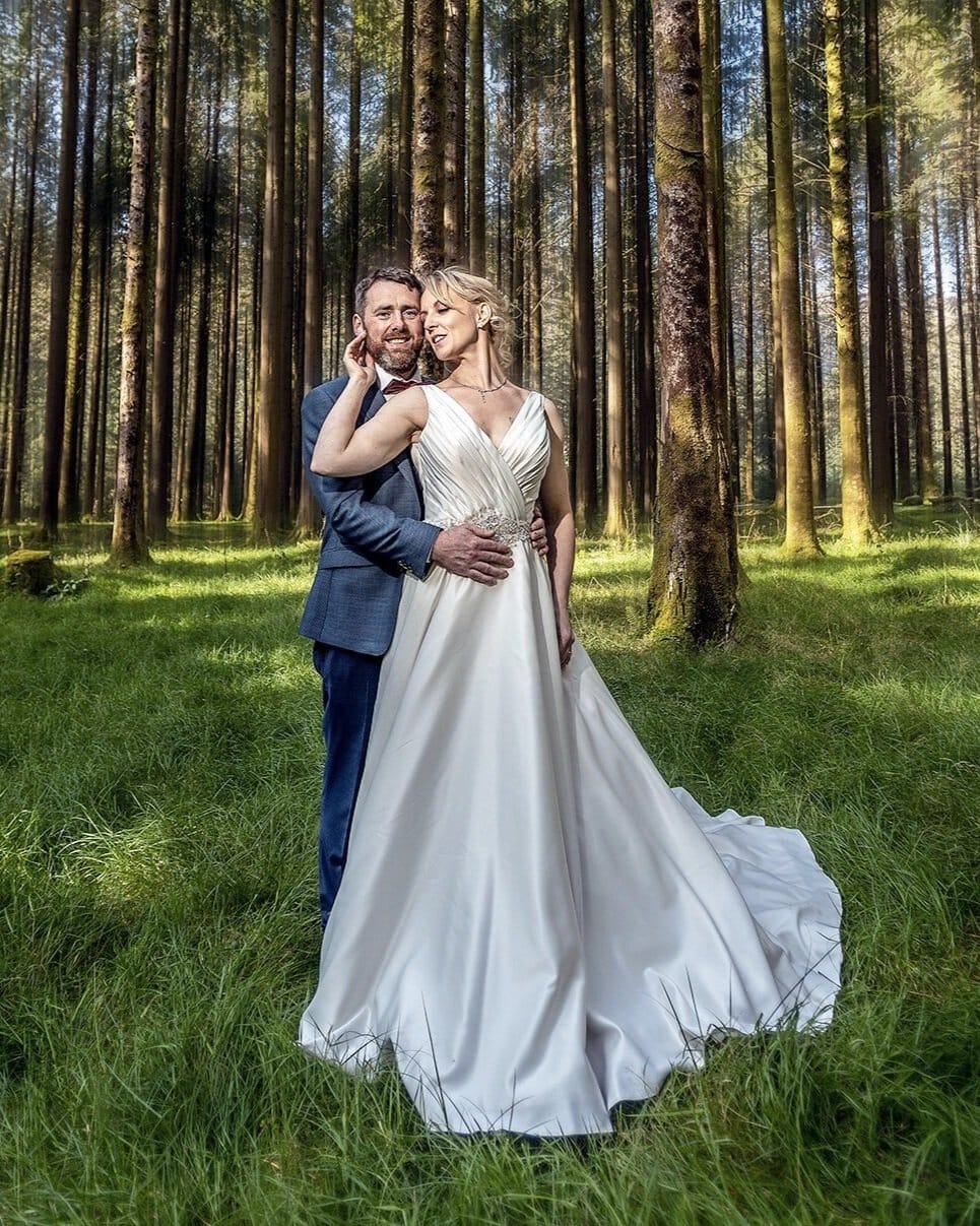 Bride and groom sharing a quiet romantic moment at Gougane Barra woods Co Cork