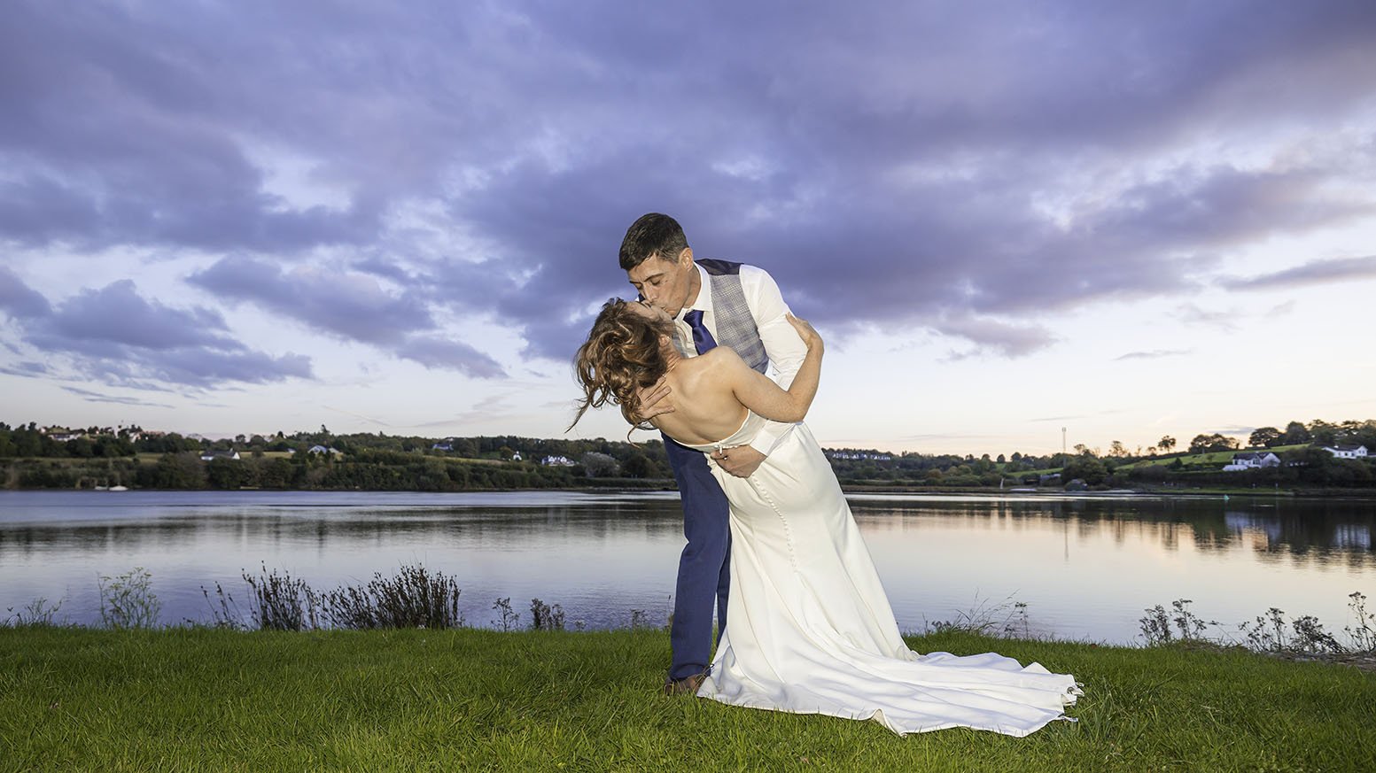 Bride and groom sharing a romantic moment by the River Slaney at Ferrycarrig Hotel – JOD Photography