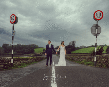 Bride and groom walking hand-in-hand on the pier at Dingle, Kerry, JOD'Photography