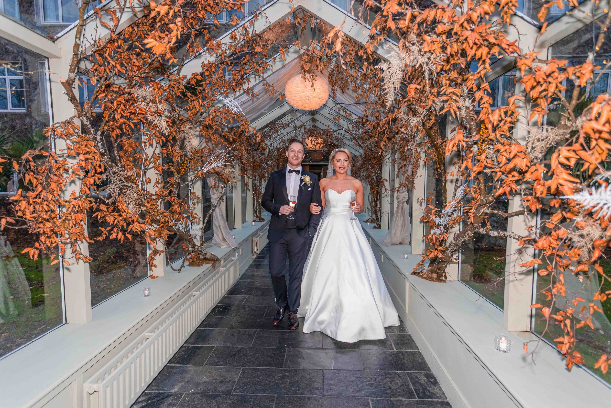 Bride and groom walking the stunning hotel that is The Great southern hotel Killarney