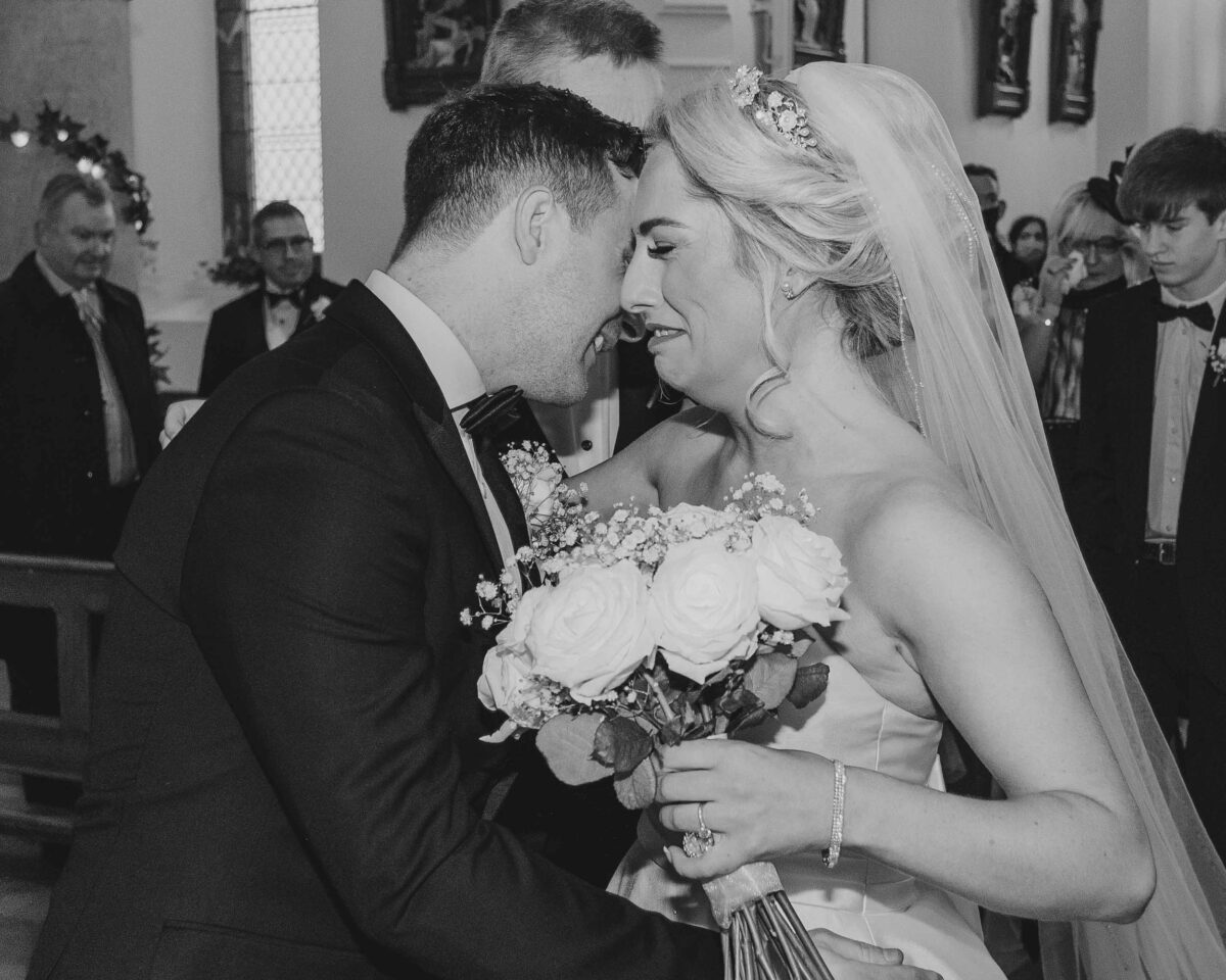 Bride cries as she embraces the groom at a church on Valentia island co kerry