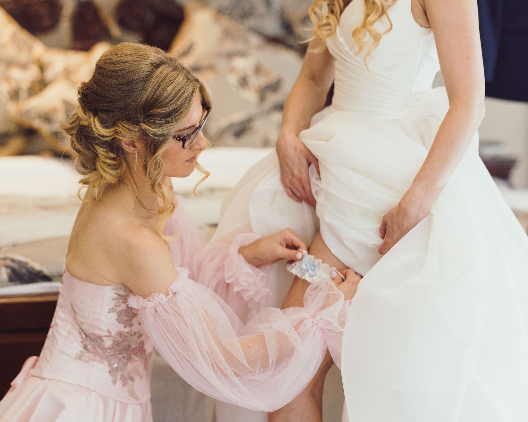 Bridesmaid putting the garter on the bride in a Waterford hotel reland