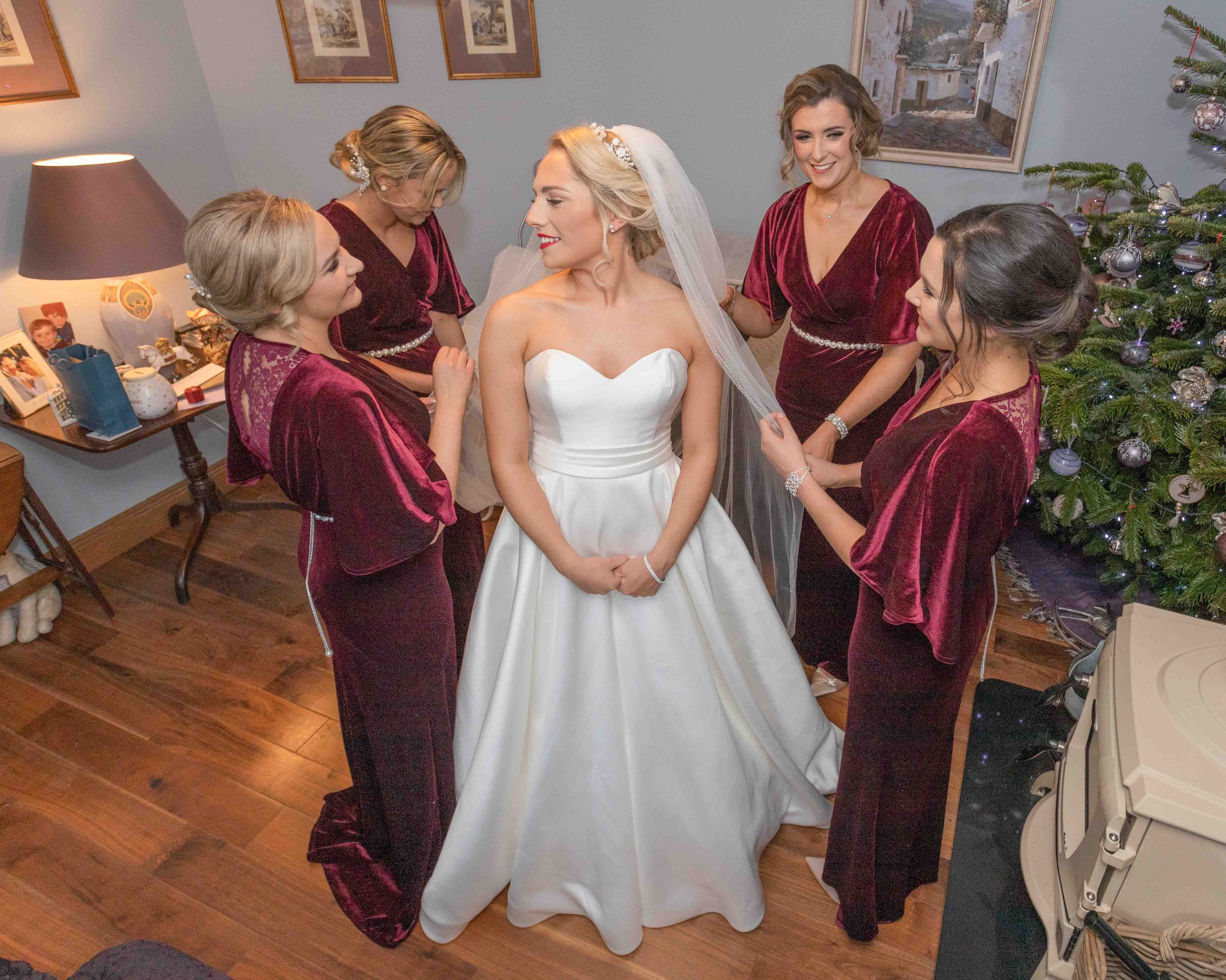 Bridesmaids fixing the bride on the morning of her wedding in Kerry