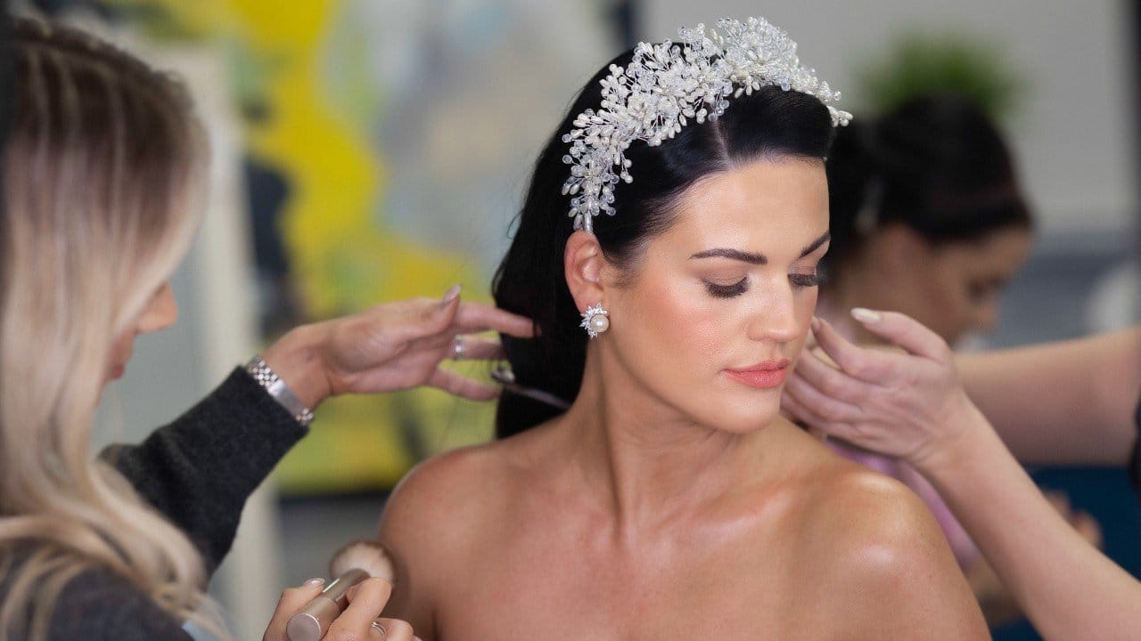 Dramatic wedding shot of the bride and groom by a waterfall in Killarney National Park, JOD'Photography