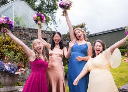 Fun Loving bridal party cheering and raising the wedding flowers in West Cork