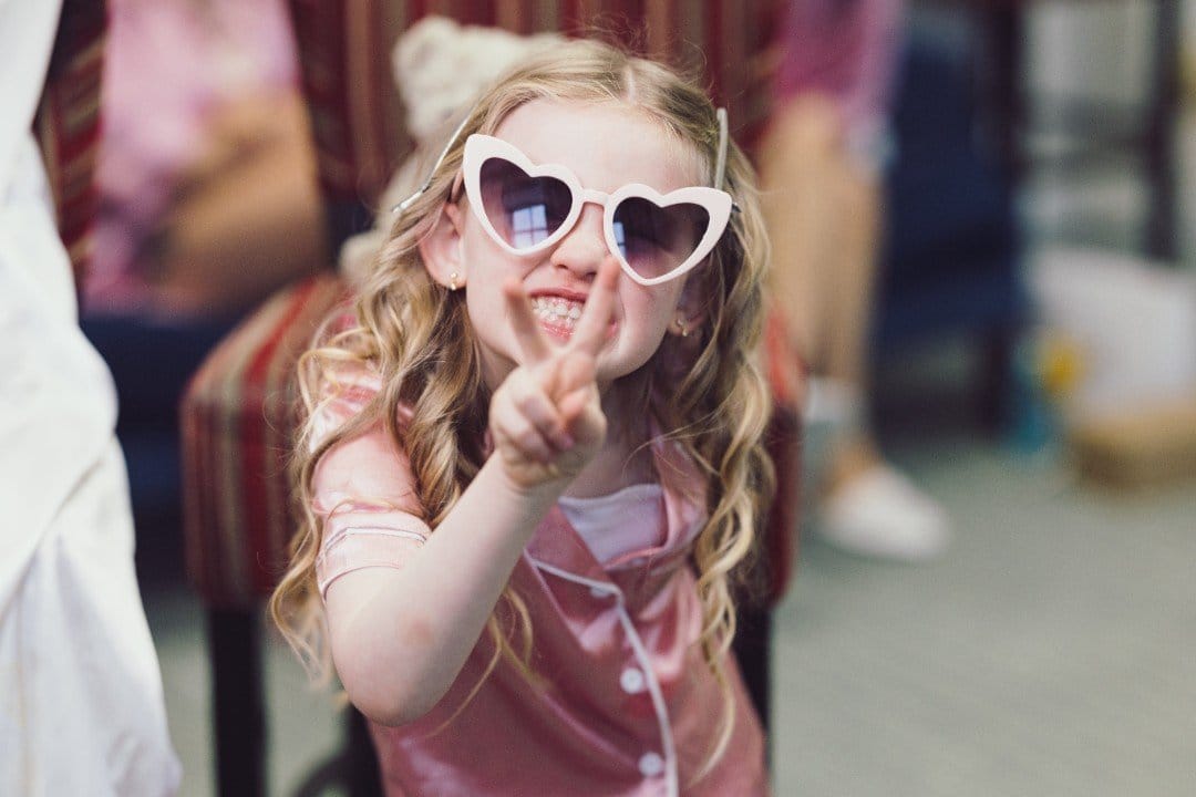 Fun loving flower girl joking around in front of the camera in Cork