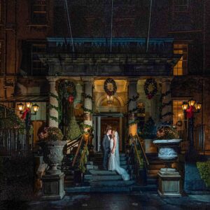 Bride and groom sharing a kiss at Christmas Outside the Great Southern Hotel in Killarney