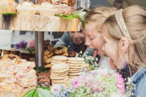 Kidsa at a wedding trying to lick the wedding cake at In Cork