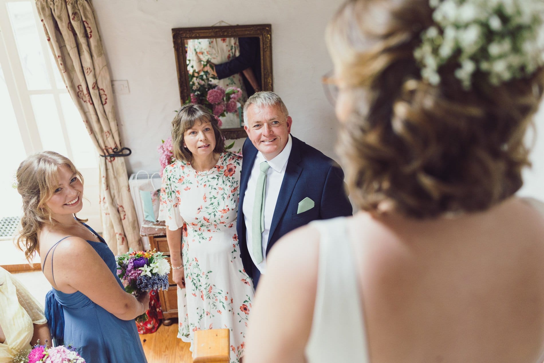 Mother and father wait patiently as there daughter comes down the stairs in her wedding dress at their home in West Cork Ireland