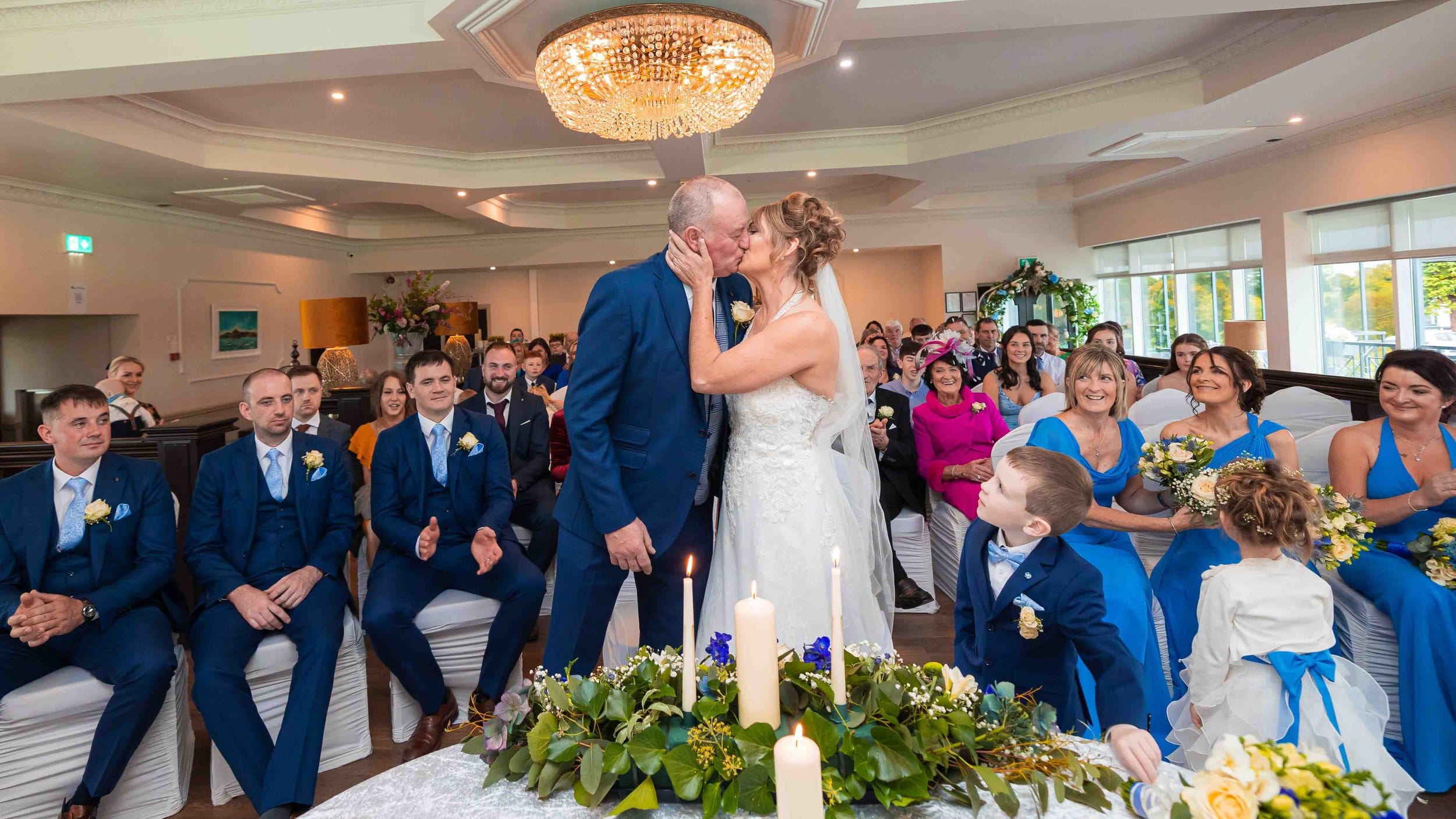Newlyweds walking hand in hand through the scenic grounds of The West Lodge Hotel – JOD Photography