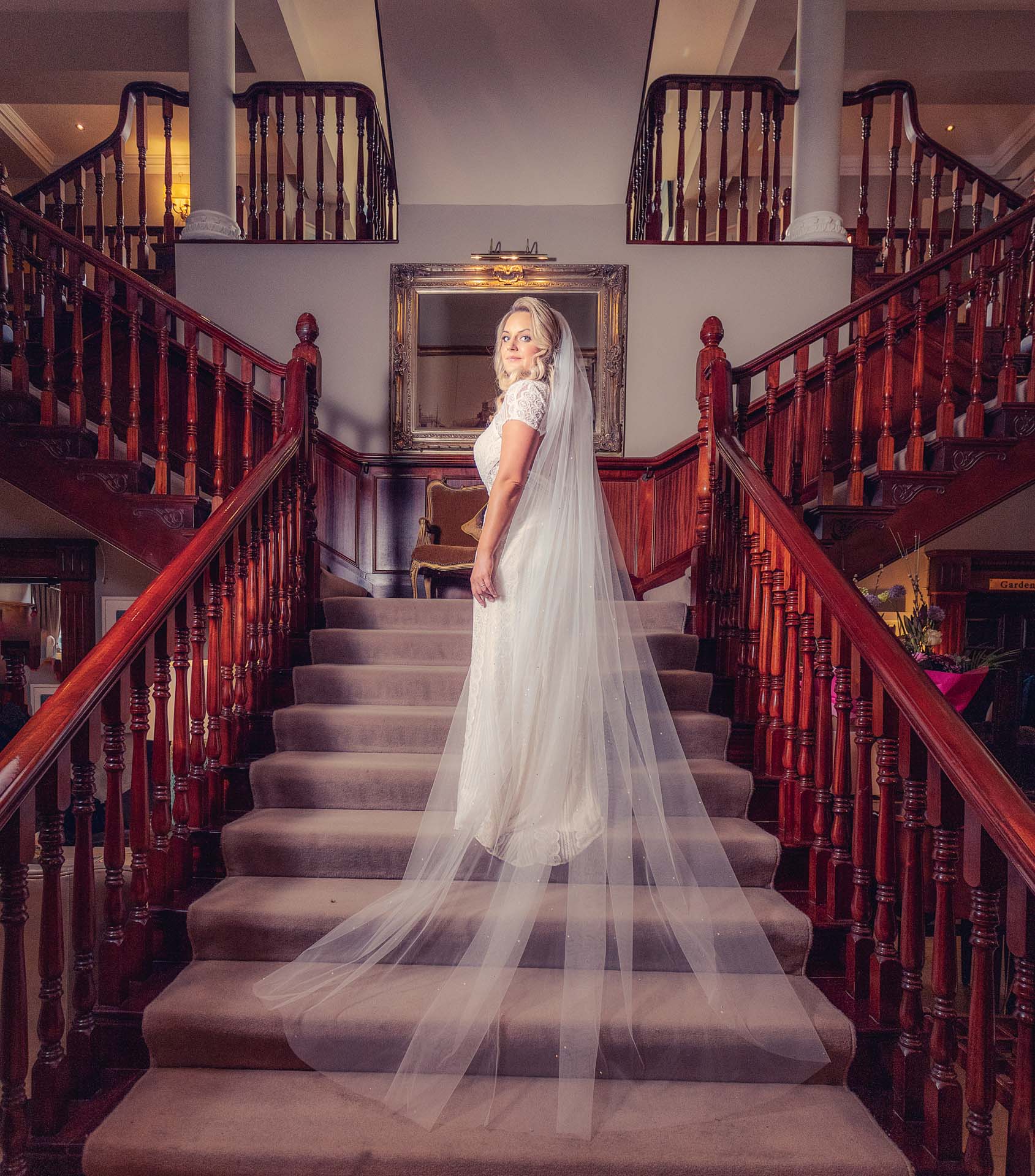 ouple walking hand-in-hand through a garden at Killarney National Park, JOD'Photography