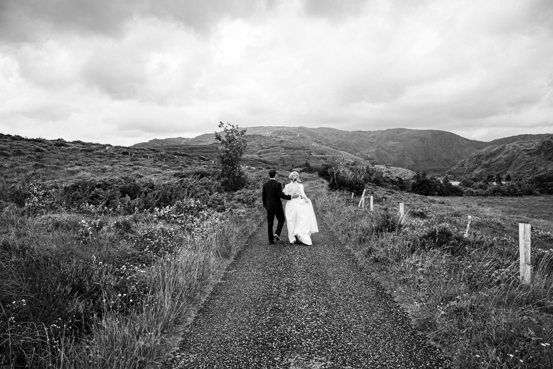 ride and groom embracing under the dramatic clouds of Killarney, Kerry, JOD'Photography