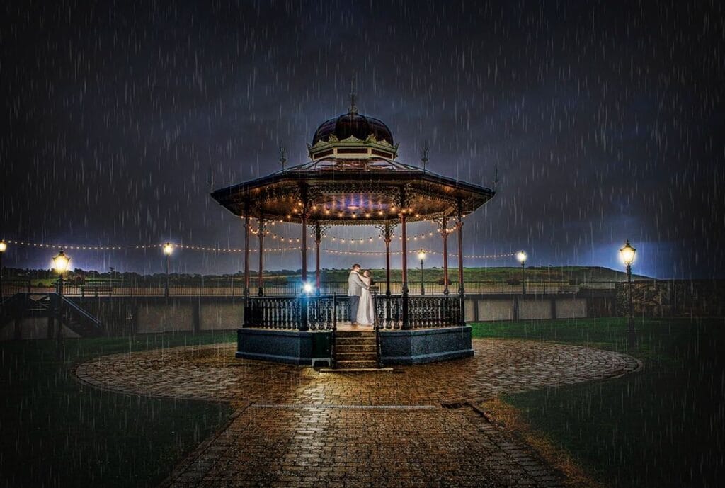 Bride and groom walking together in landscaped gardens – JOD Photography