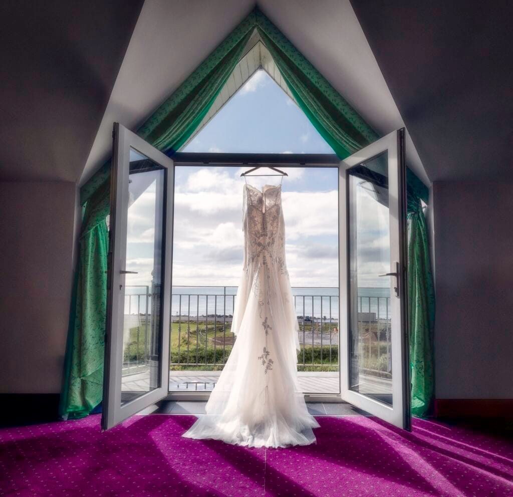 Stunning bridal dress hanging from hotel bay doors in west Cork