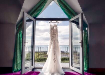 Stunning bridal dress hanging from hotel bay doors in west Cork