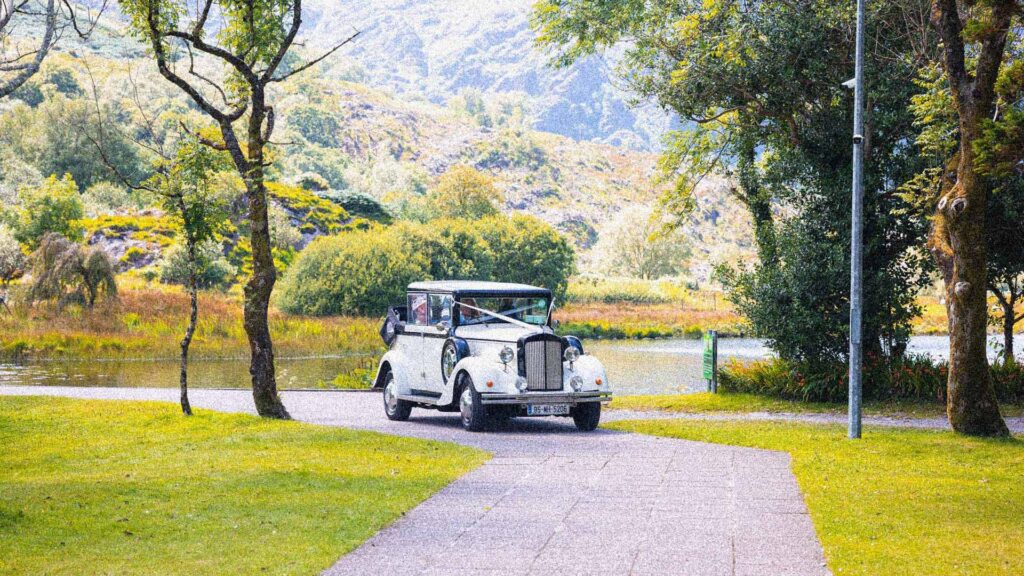 Vintage Car arriving at Gougane Barra Church West Cork Ireland