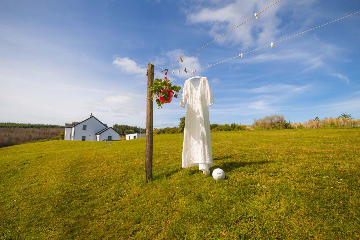 Wedding dress hanging on the line with a stunning blue sky behind it, up the Mountains in Macroom Co Cork