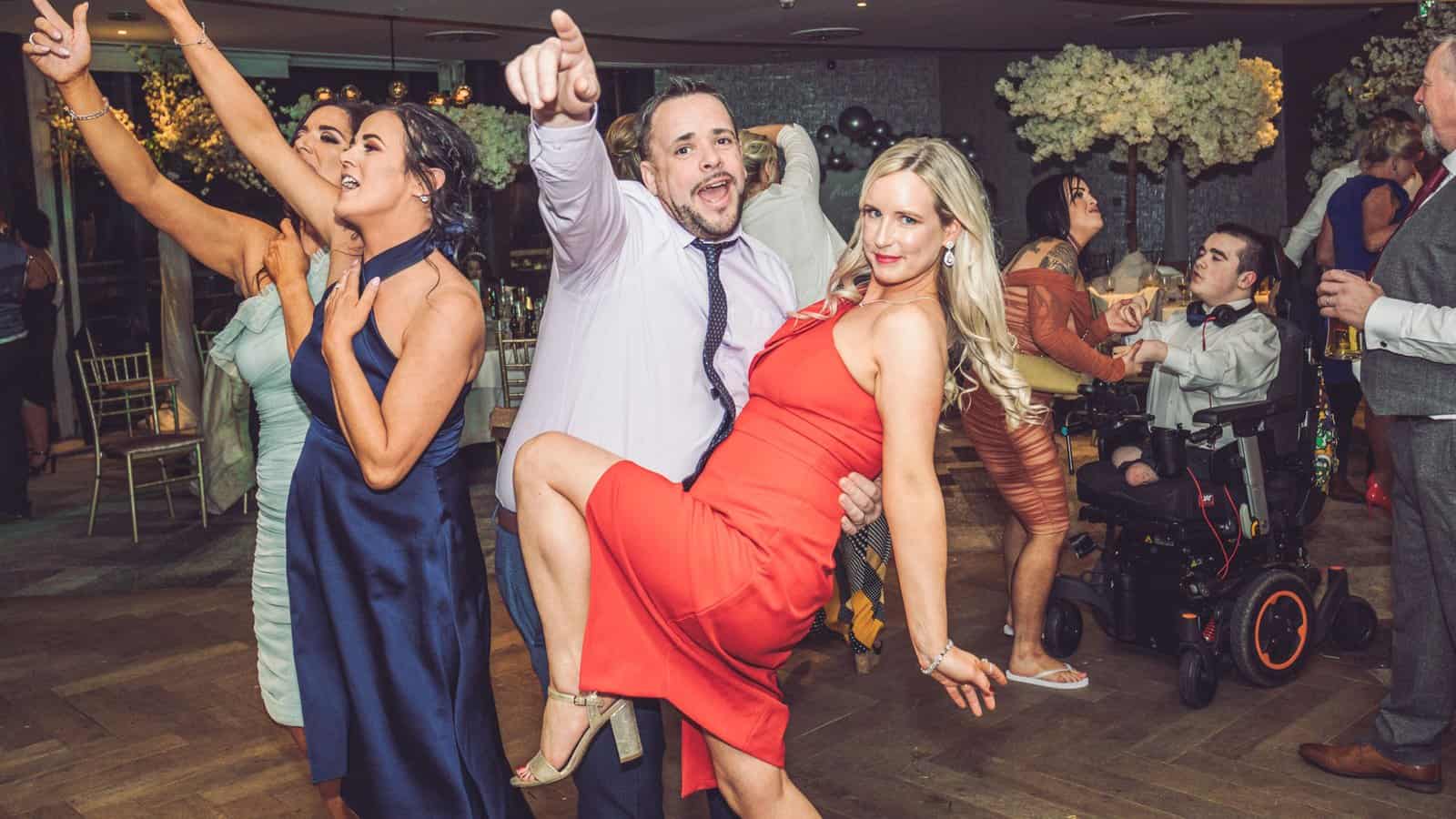 Wedding guests enjoying the reception under the glowing lights in Killarney, JOD'Photography