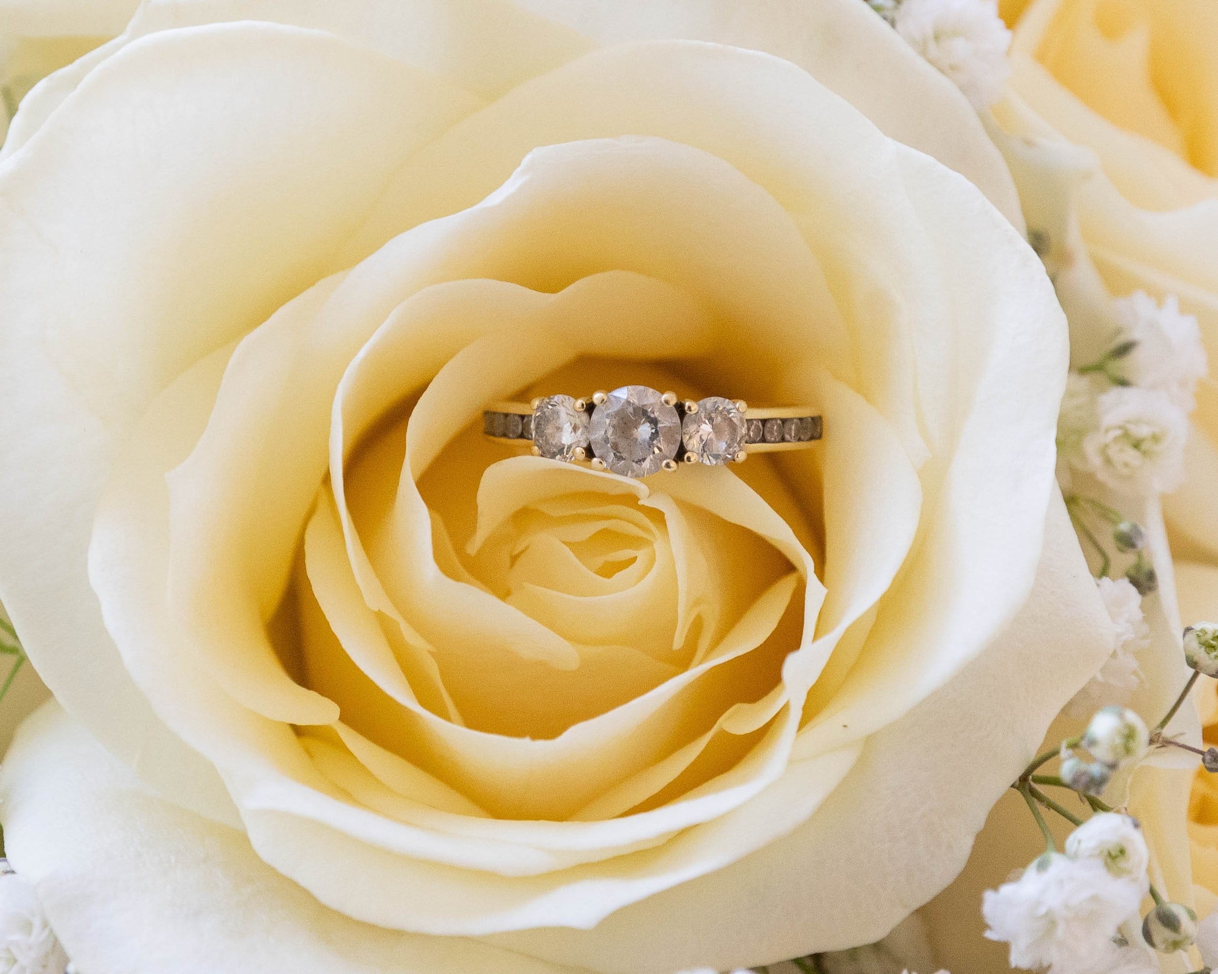 Wedding ring inside a bunch of yellow roses