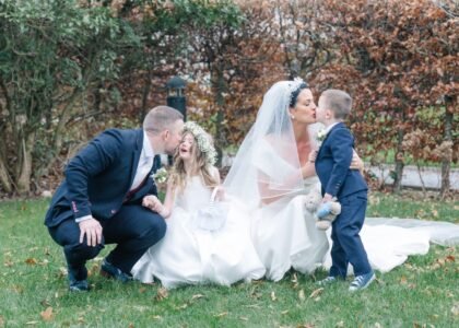 Bride and groom kiss their children on their wedding day in Cork Hotel venue