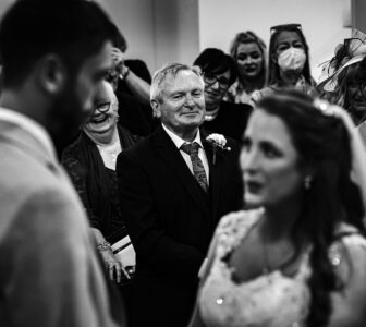 Father looking at his daughter saying her vows in cork wedding