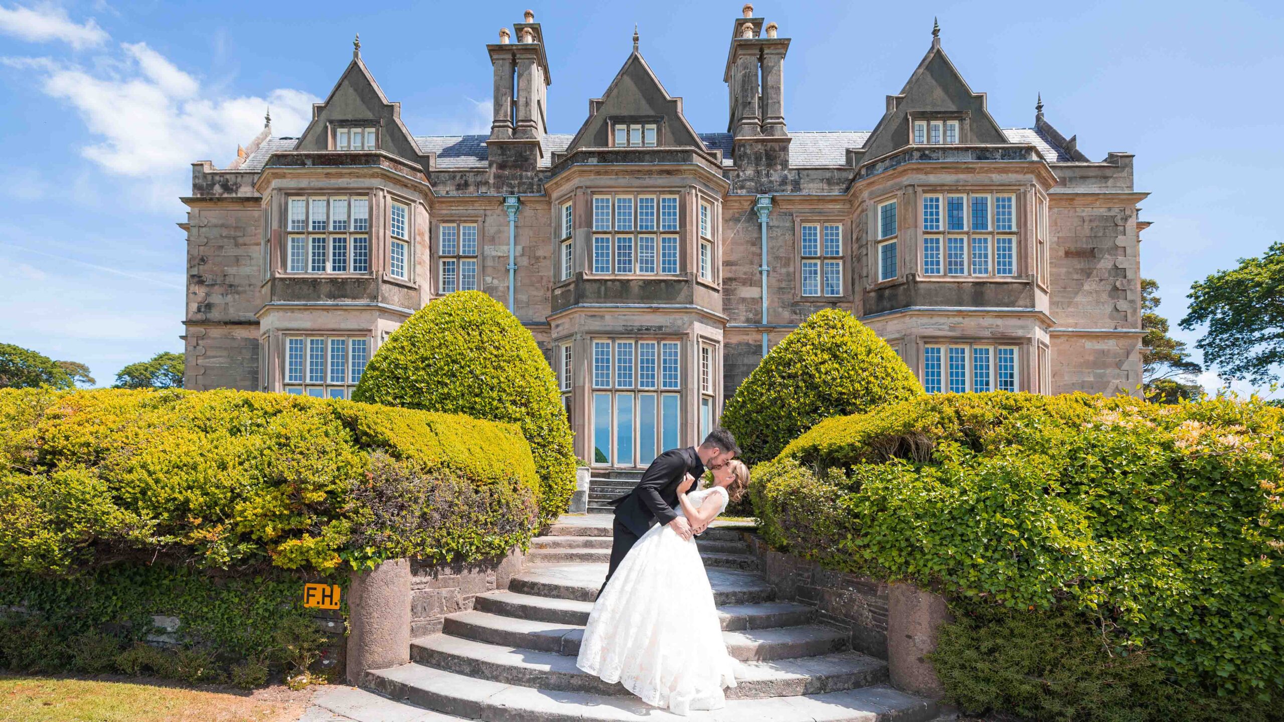 Romantic dip kiss in front of Muckross House Hotel JODPhotography