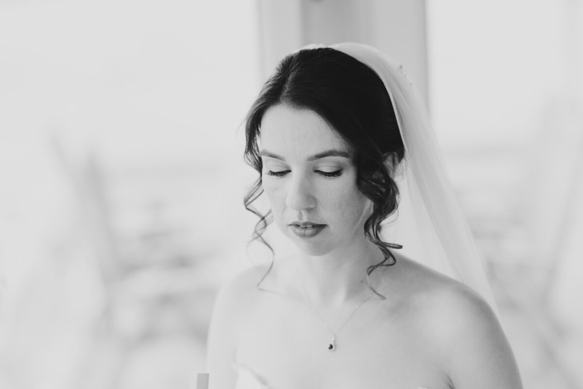 Black and white portrait of a bride in a veil looking down, Kinsale wedding