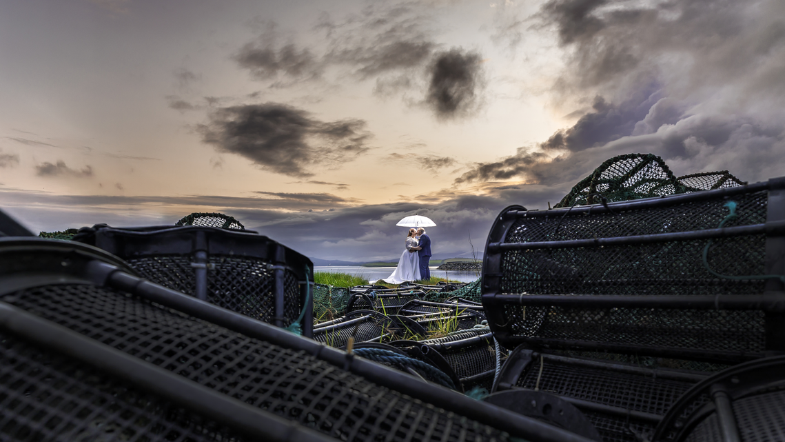 Sunset wedding photo in Bantry West Cork Sheila and Paul share a quiet moment outside the Maritime Hotel after their rainy Bantry House ceremony JODPhotography