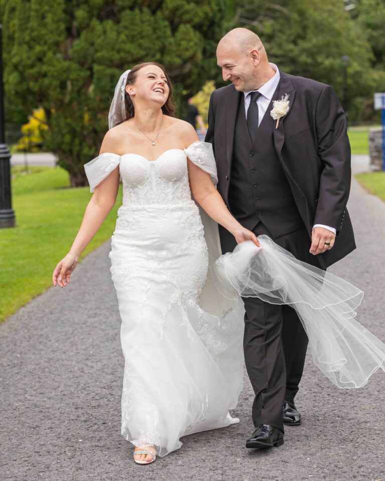Bride and groom walking together outside the wedding venue