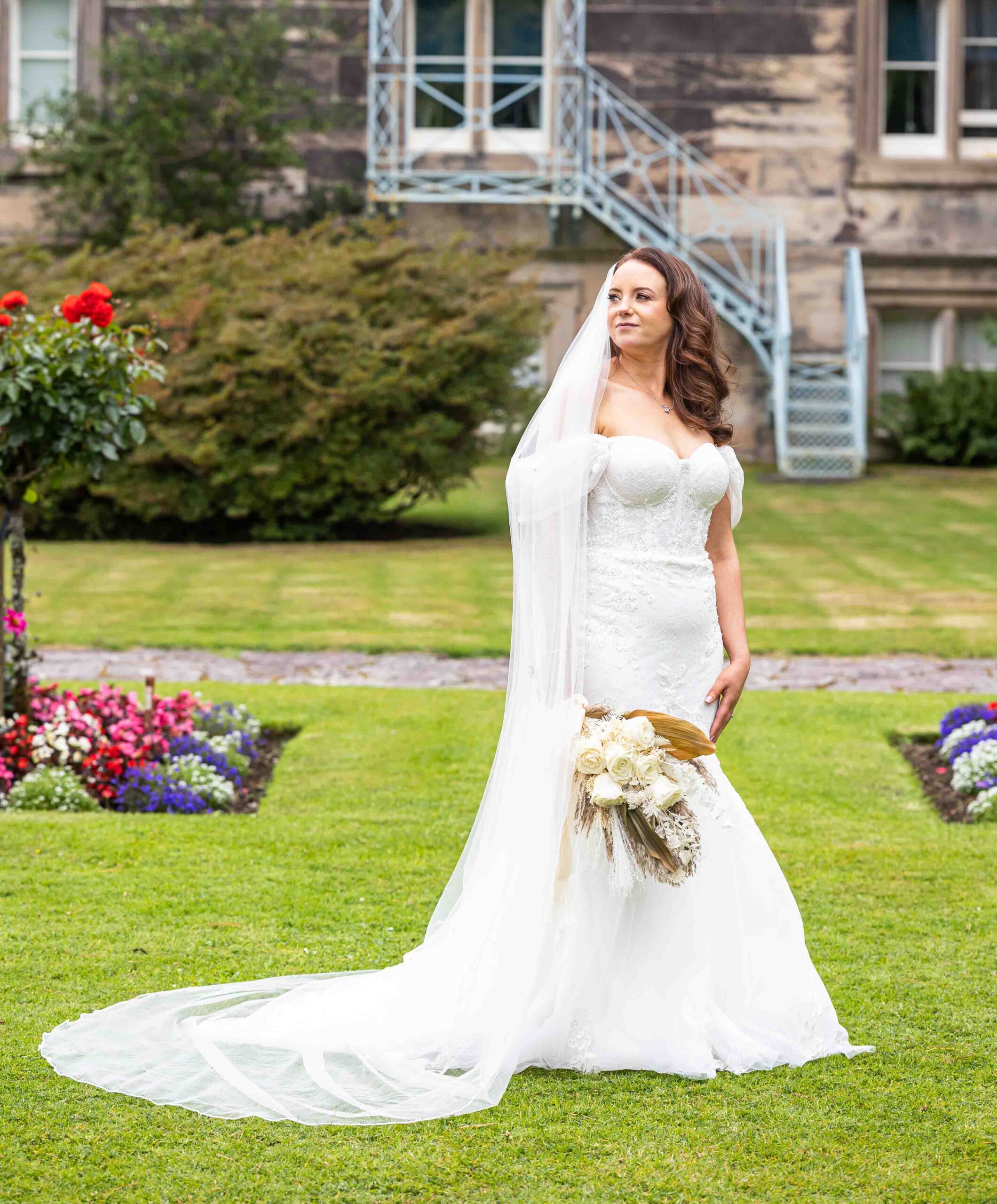 The newlyweds walking hand in hand through the gardens JOD Photography