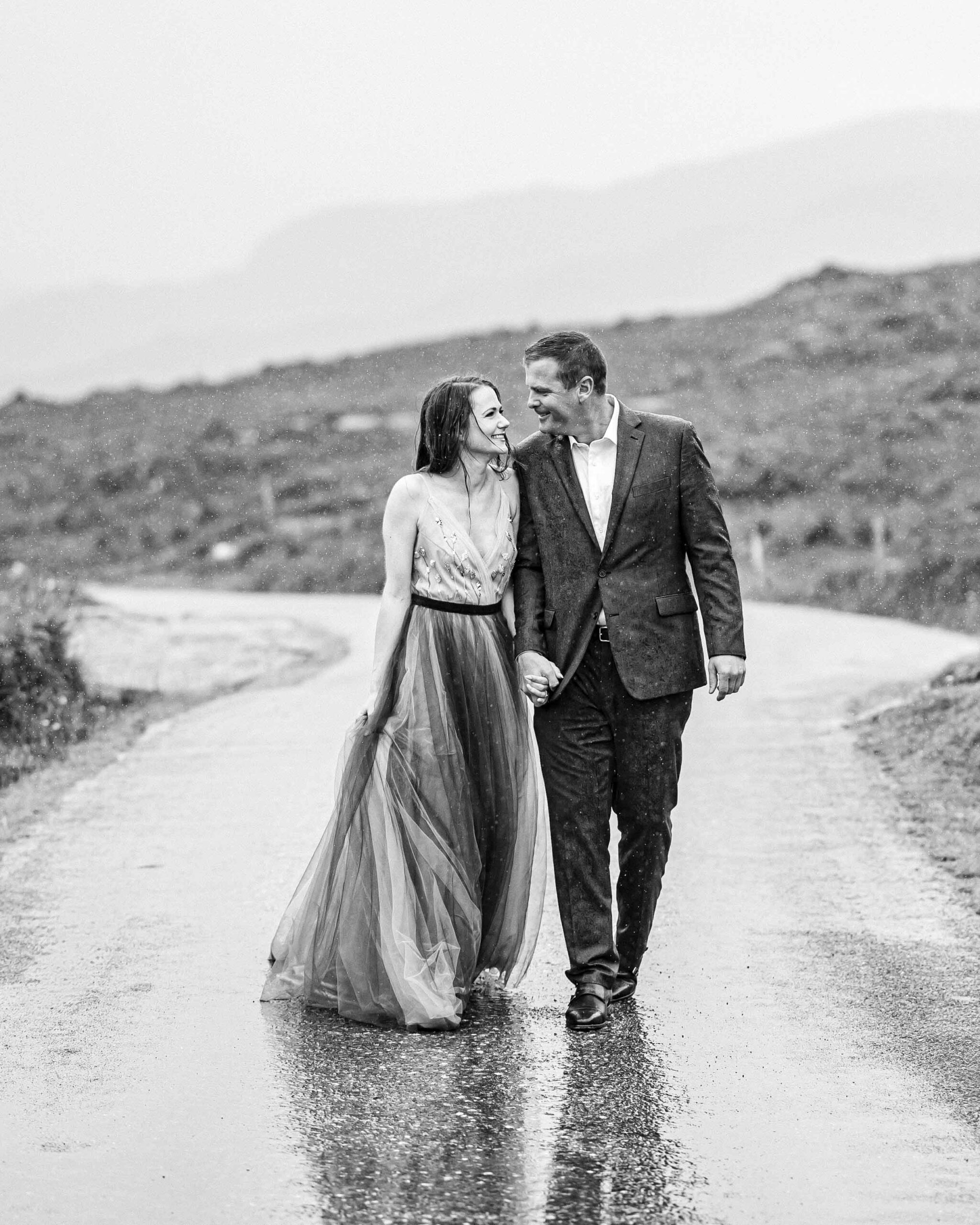 Heather and Matt embracing the rain at a mountain overlook in the Gap of Dunloe JODPhotography