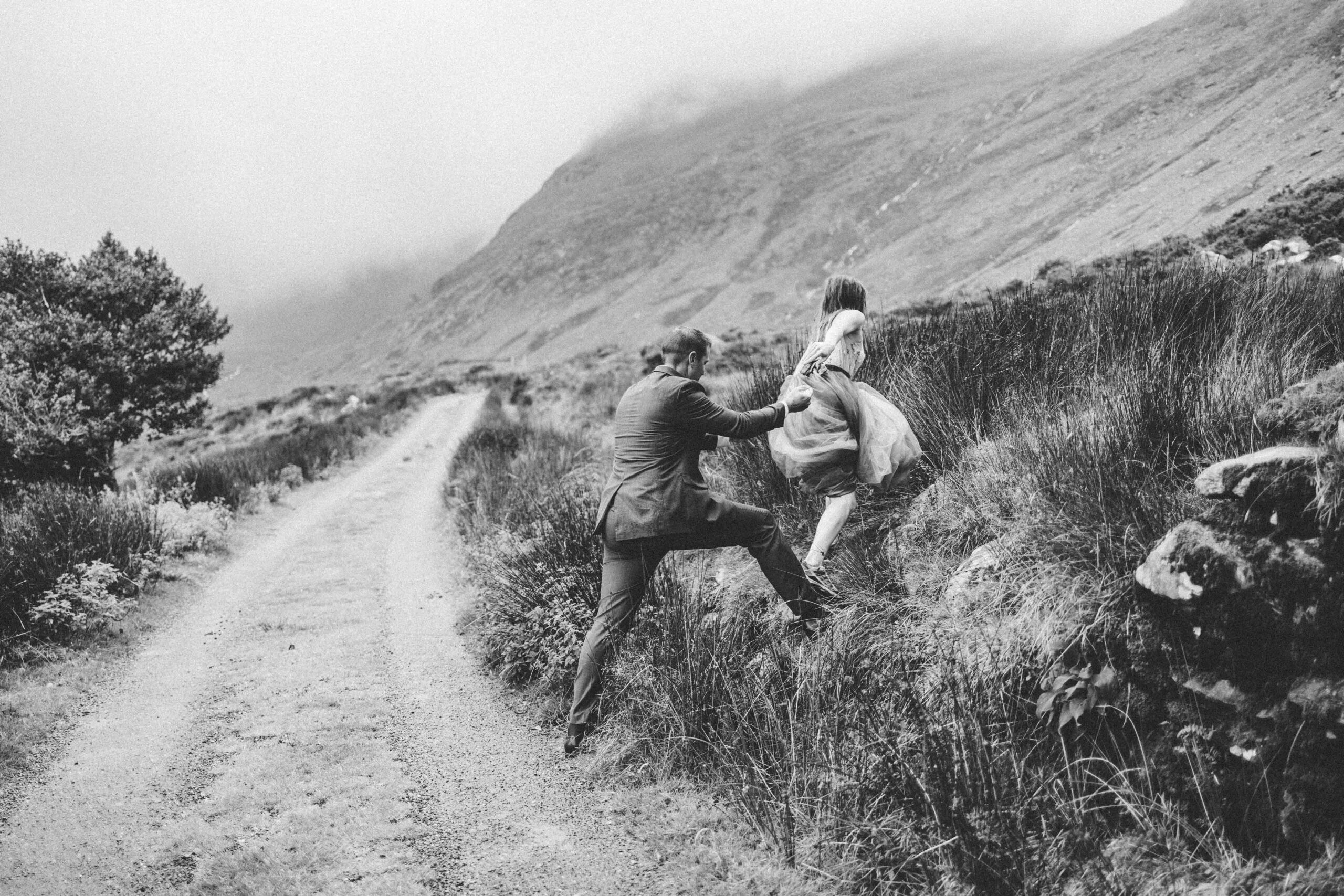rocky old slate house with rugged backdrop of the Black Valley behind the couple - JOD'Photography