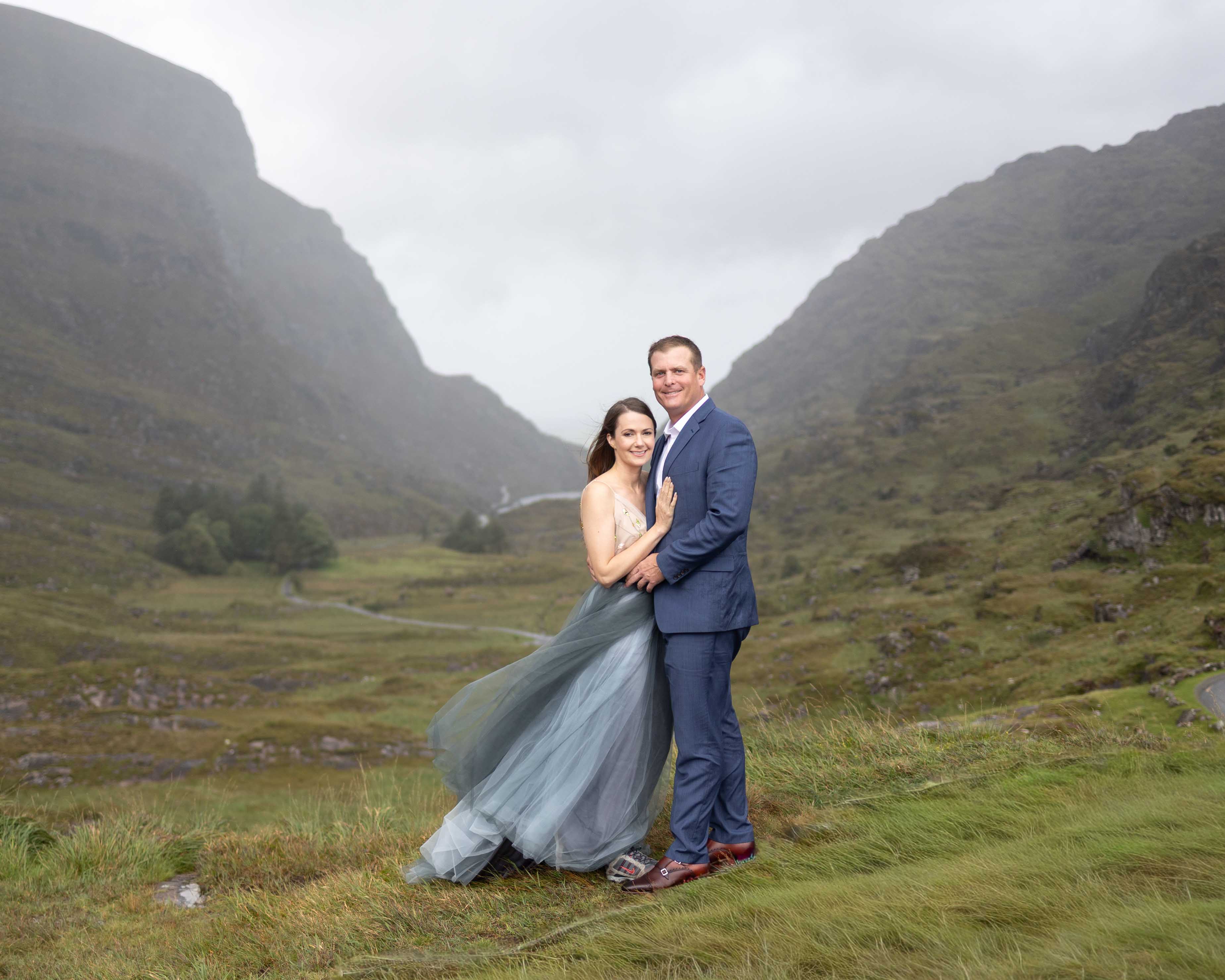 Heather and Matt embracing the rain at a mountain overlook in the Gap of Dunloe - JOD'Photography