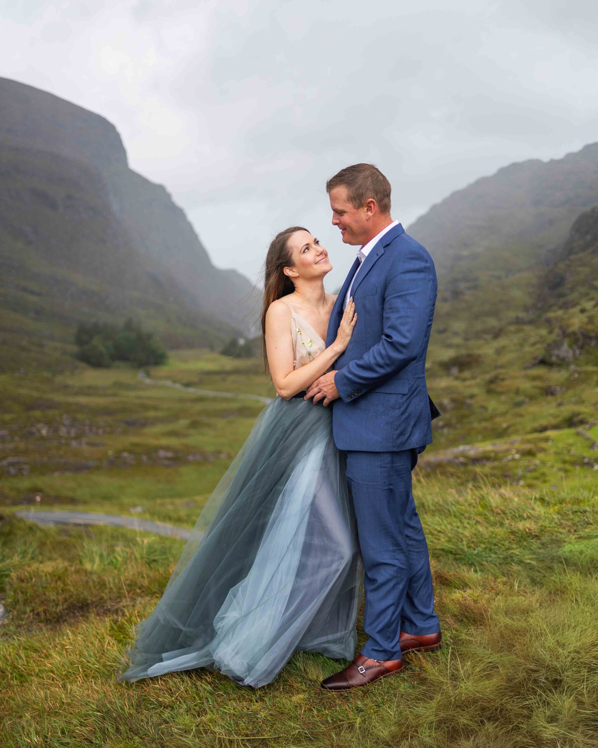 the rugged mountain road winding through the Gap of Dunloe with the couple in view JODPhotography