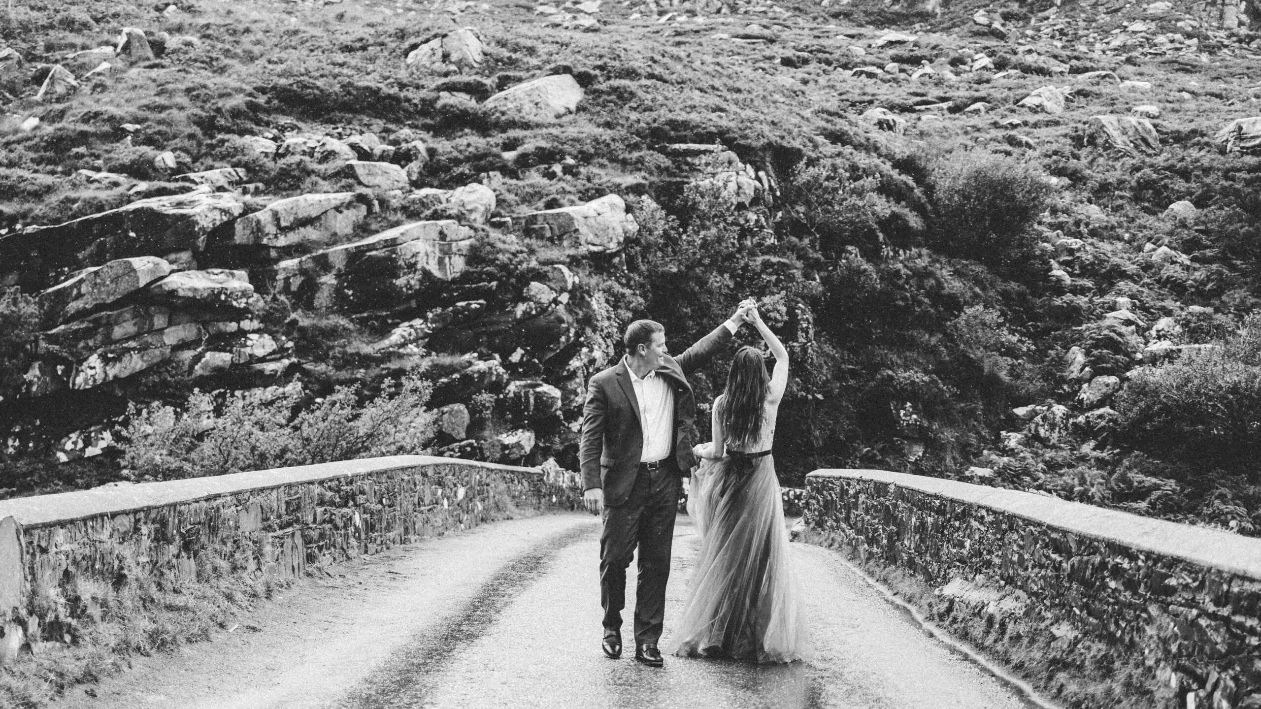 Heather and Matt embracing the rain at a mountain overlook in the Gap of Dunloe - JOD'Photography