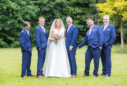 Bride walking down red carpet with guard of honour – JOD Photography