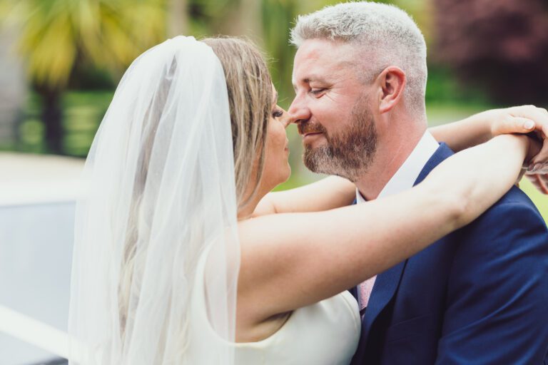 Bride and groom embracing in the garden at The Mills Inn, Ballyvourney, Co. Cork
